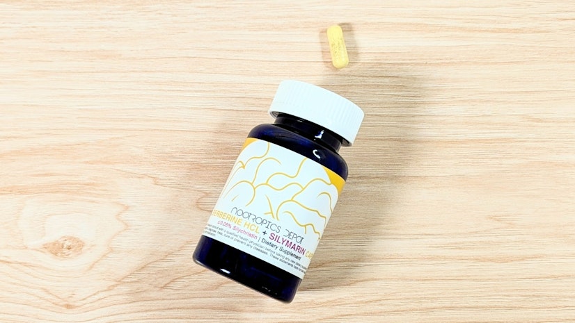 A bottle of Nootropics Depot Berberine + Silymarin on a wooden surface.