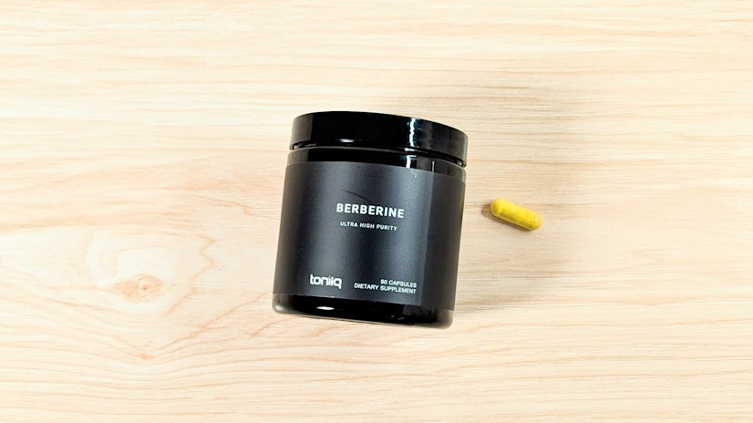 Black bottle of Toniiq Ultra High Purity Berberine beside a one-capsule serving