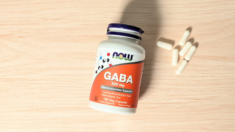 NOW GABA Capsules on a wood surface.