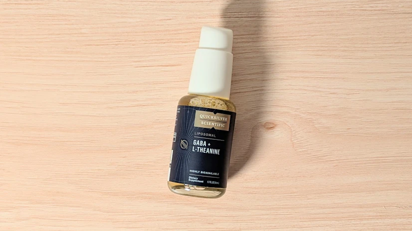 Quicksilver Scientific GABA + L-Theanine on a wood surface.