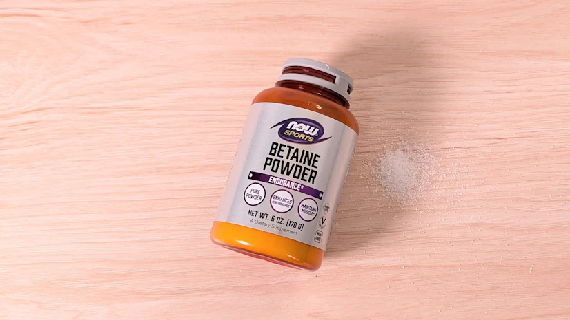 NOW Sports Betaine Powder on a wood surface