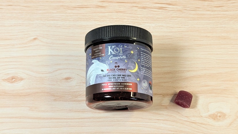 Koi Complete Nighttime Rest on wood surface next to one-gummy serving