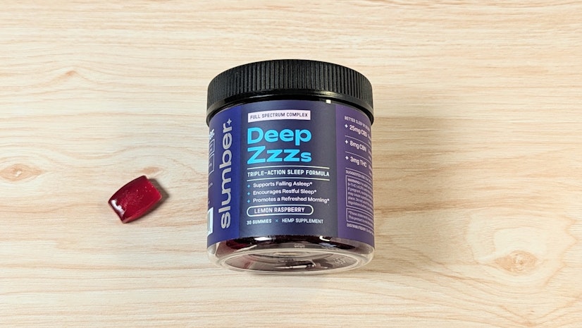 Slumber Deep Zzzs gummies on wood surface next to one-gummy serving