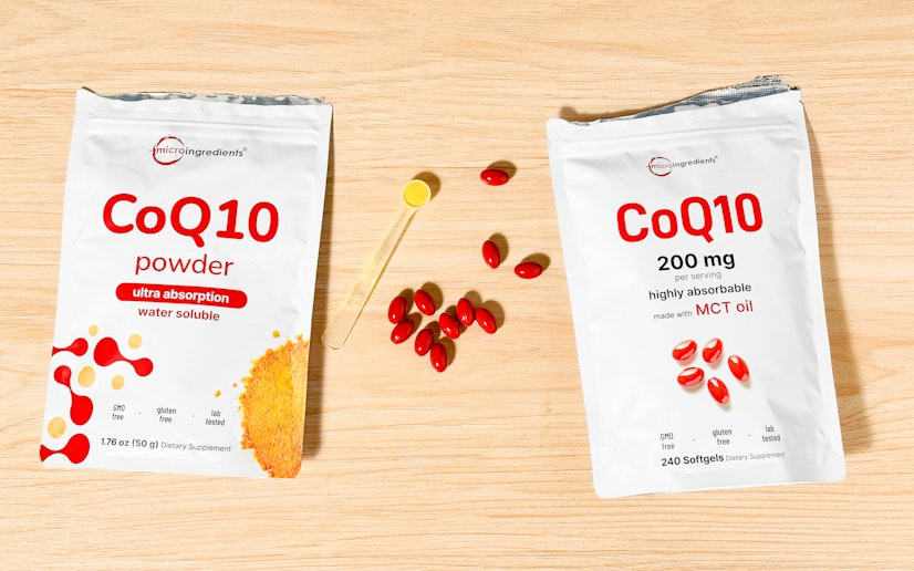Two products by Micro Ingredients — the powdered CoQ10 and CoQ10 softgels — sit next to their packaging on a wood surface