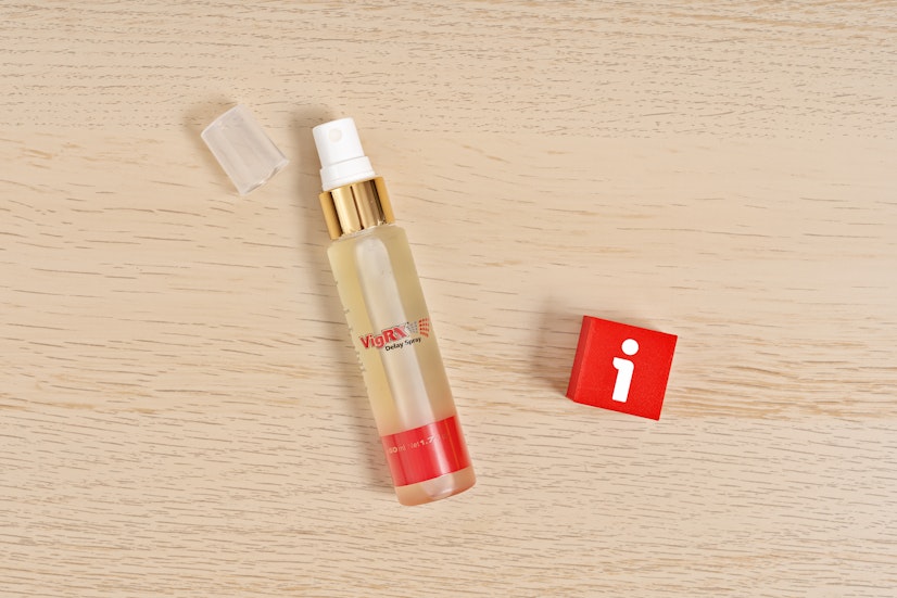 VigRX Delay Spray 50 mL bottle with open cap on wood surface, featuring lidocaine