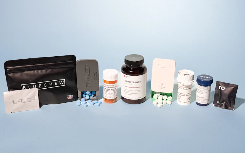 An array of the best ED treatments in their bottles and tins against a blue backdrop