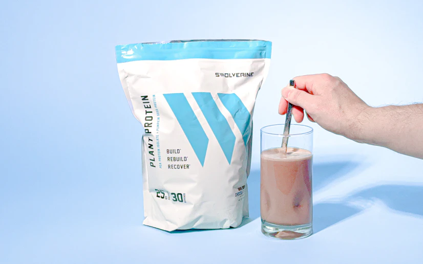 Swolverine Plant-Based Protein bag with glass containing mixed protein drink.