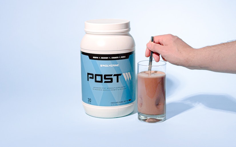 Swolverine Post bottle with glass containing mixed protein drink.