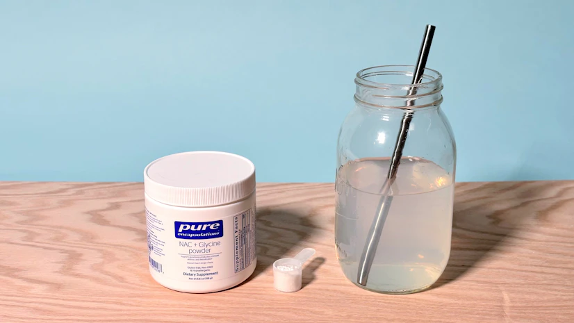 A picture of the Pure Encapsulations supplement bottle and mixed drink