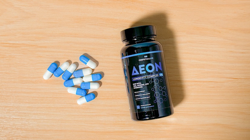 Perpetua Life AEON NMN supplement on a wood countertop