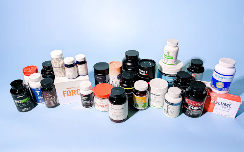 A cornucopia of more than two dozen testosterone boosters grouped against a blue background.