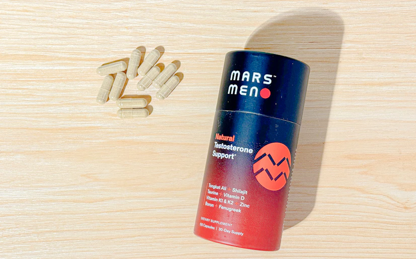 Mars Men bottle and capsules on a wood surface.