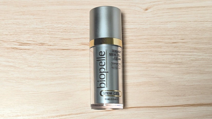 Bottle of Biopelle Tensage Stem Cell Cream on a wooden surface.