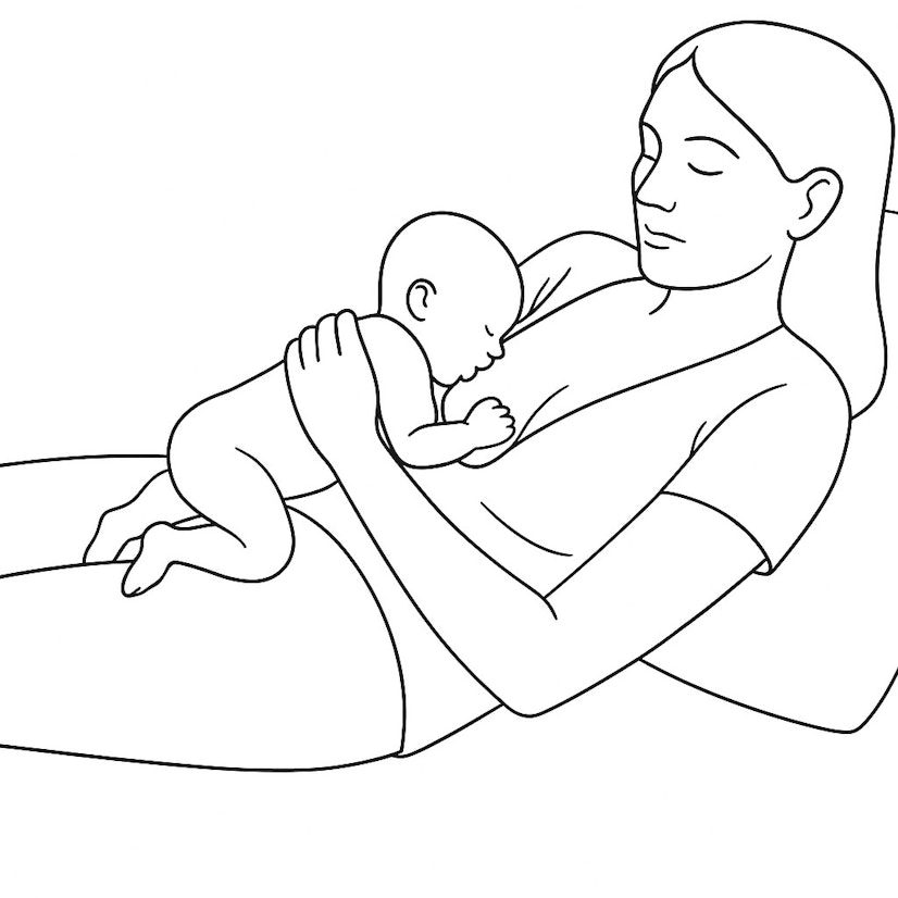 Parent breastfeeding in a laid-back position, reclining comfortably while the baby lies tummy-down against the chest.