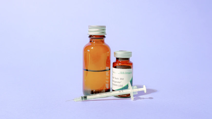 dihexa vial and syringe against a purple background
