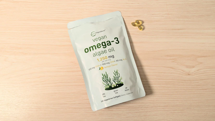 Bag of Micro Ingredients Vegan Omega-3 Algae Oil softgels on a wood surface.