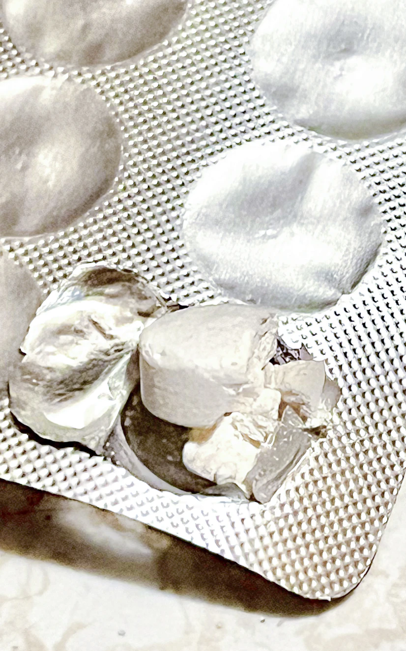 Nature City oral probiotic lozenge broken from pushing through its blister pack.