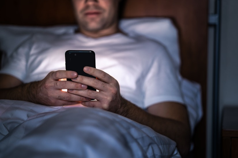 Person Using A Phone In Bed At Night