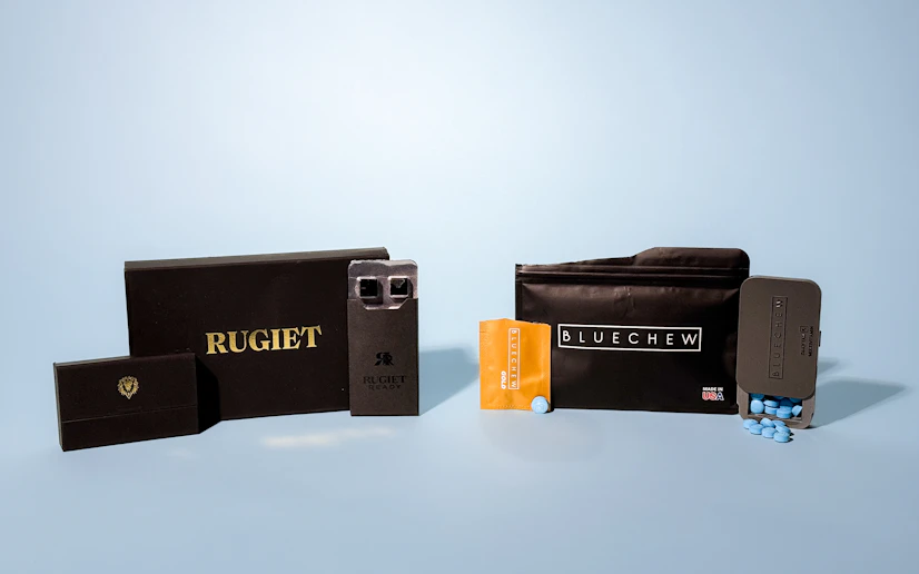 Rugiet and Bluechew packaging and lozenges in front of a blue background