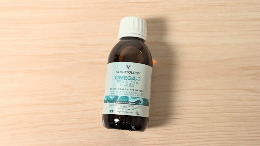 Bottle of Vegetology Omega-3 EPA & DHA Liquid on a wood surface